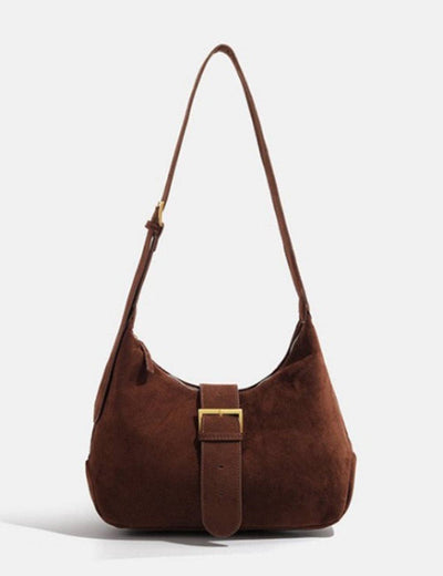 Brown suede handbag with a gold buckle on a white background