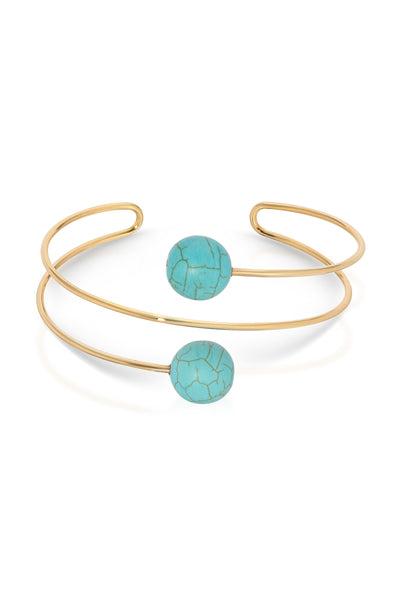 Gold bracelet with turquoise beads on a white background
