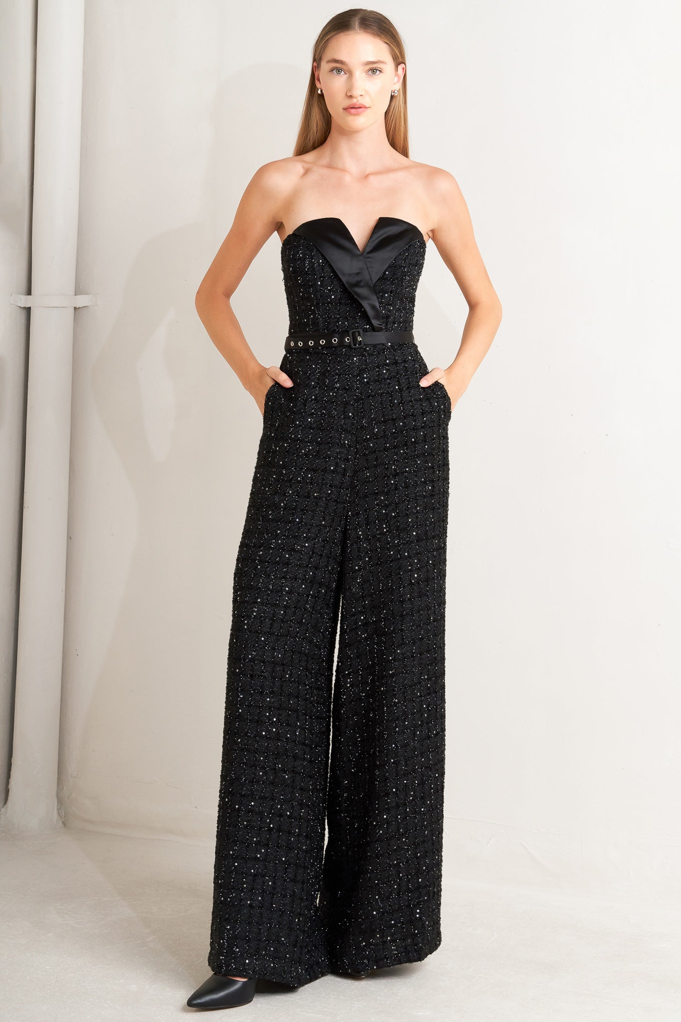 Black strapless jumpsuit with wide-leg pants worn by a model on a white background