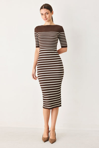 A woman modeling a brown and white horizontally striped ribbed knit midi dress with short sleeves and a boat neckline, paired with brown pointed-toe heels, against a plain white studio background.
