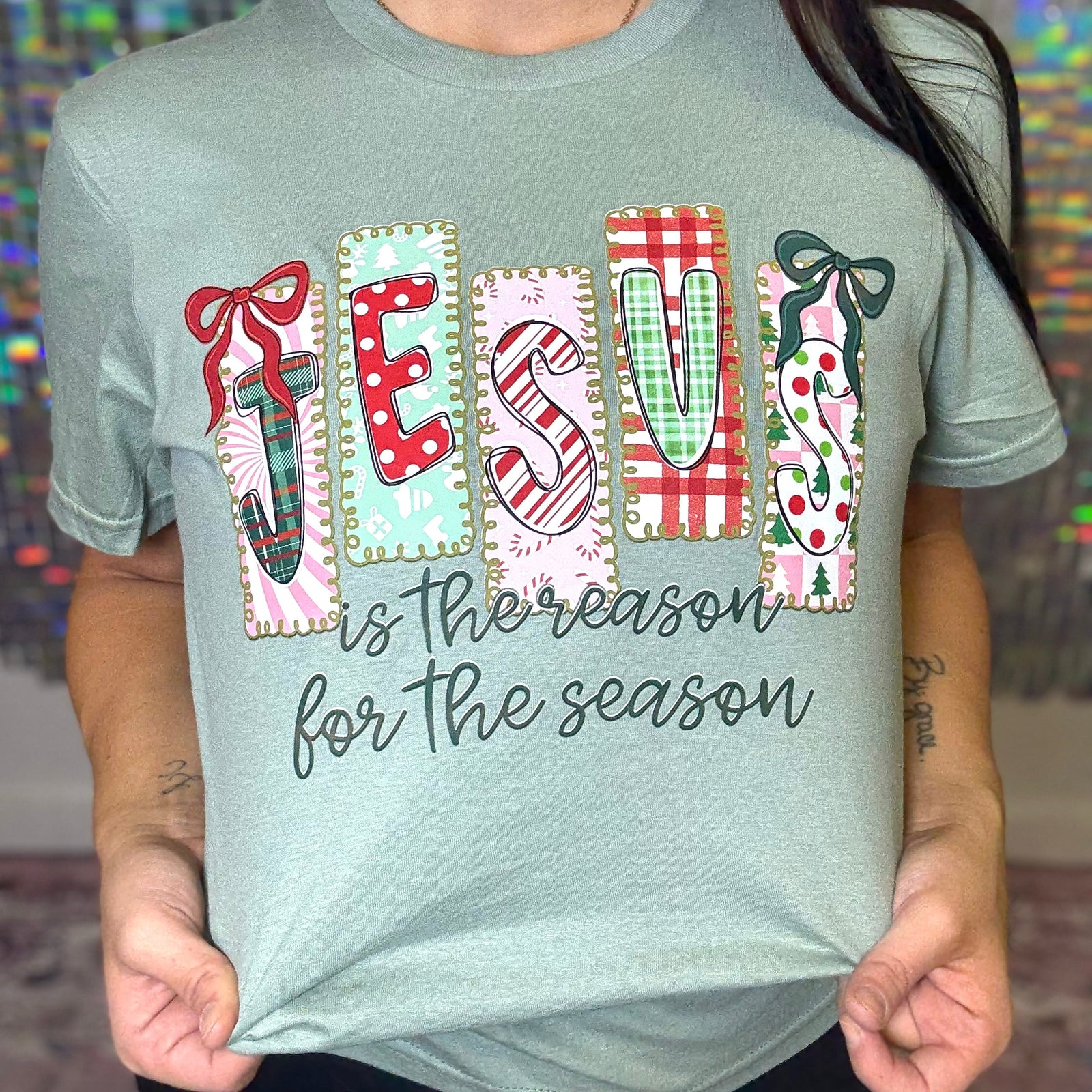 T-shirt with Christmas-themed design and text held by a person