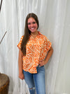 Ester - A Zebra Print Button Down Top with Cap Sleeves