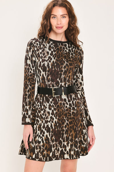 A woman modeling a long-sleeve leopard-print dress with a black belt, photographed against a plain light background.